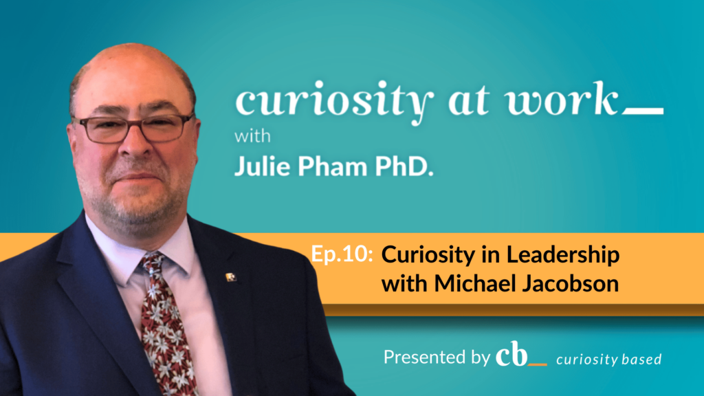 Michael Jacobson posing with Curiosity at Work podcast banner