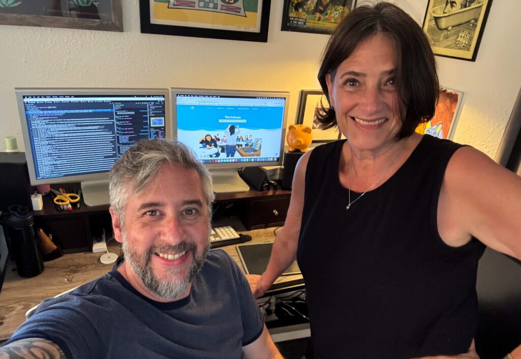 Daimian Lix and Maia Segura of Creative Catalyst Communications posing in front of updated CuriosityBased website on monitor